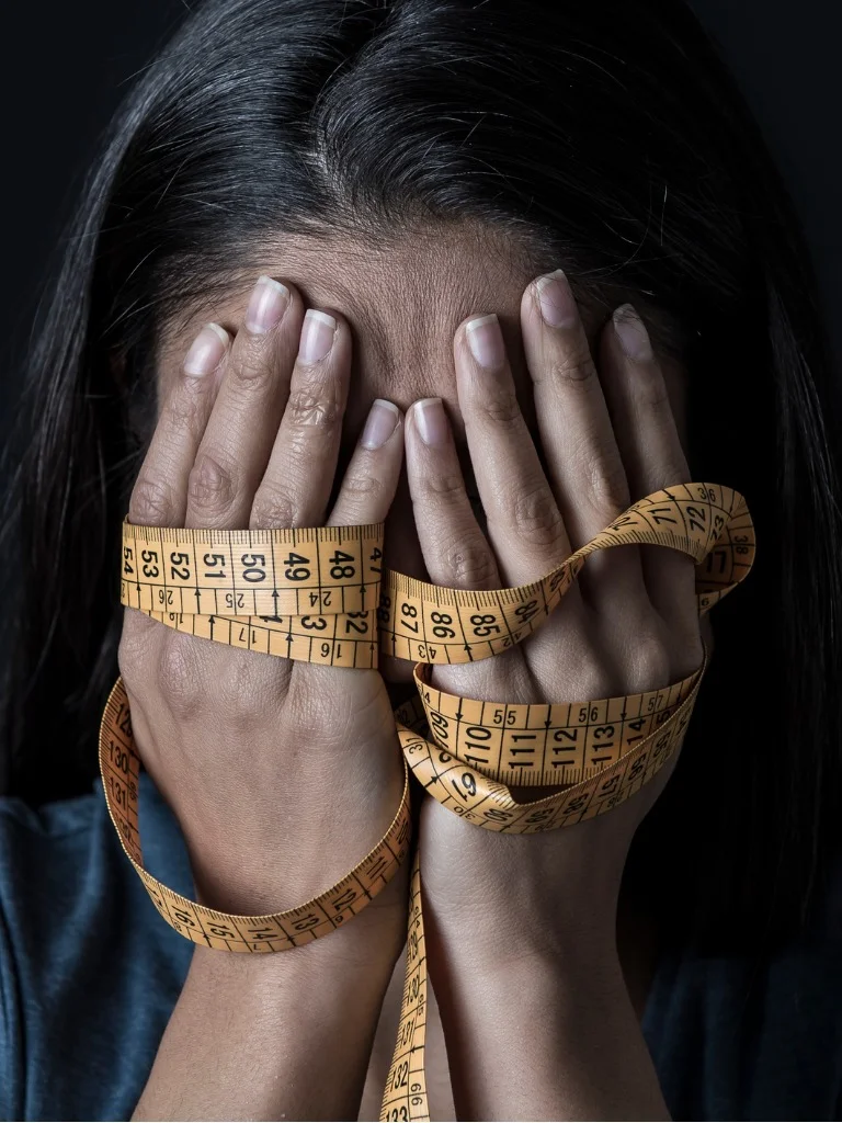 close-up-hands-wrapped-in-tailor-measure-tape-covering-face-of-young-depressed-and-worried.jpg_s1024x1024wisk20cmFiPgK9_eZcFG8ZxM8VyDI2QvSV1Sj2CpdZSTJiifrA